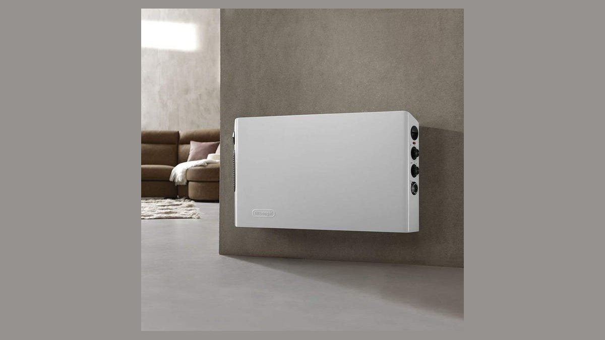 A modern portable space heater positioned in a bright and cozy living room.