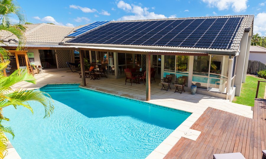 A modern residential swimming pool featuring an efficient Heliocol solar heating system installed overhead.