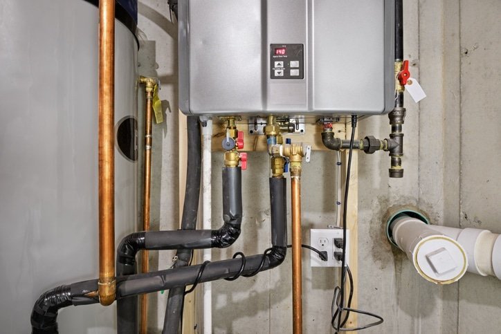 A modern water heater stands in a clean utility room ready for installation.